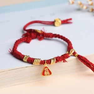 Zakiram Goddess of Wealth Tibetan red string protection bracelet flat lay view