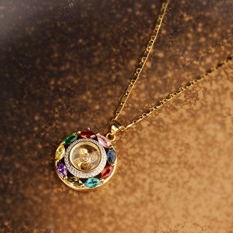 Full overhead view of gold chain and rotating zircon copper pendant necklace