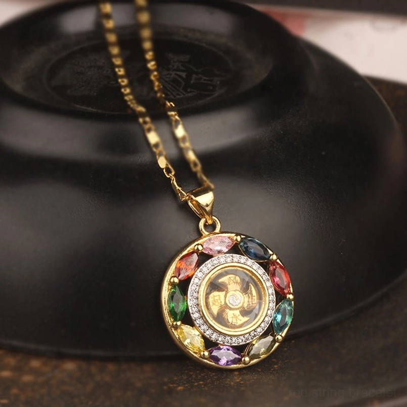 Colorful zircon rotating copper pendant necklace with gold chain on black ceramic surface