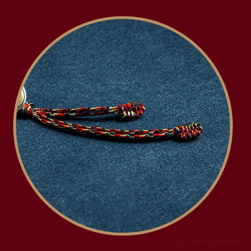 Detailed close-up of multicolor braided rope tassel on Chinese zodiac protection bracelet