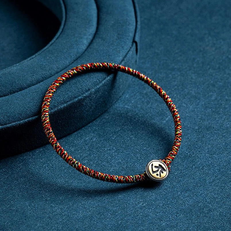 Chinese zodiac protection bracelet with mixed-color braided rope and Sanskrit engraved Buddha pendant