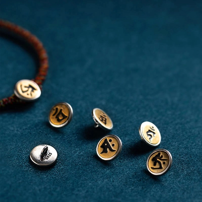 Assorted sterling silver Buddha charms and woven rope pieces showing different zodiac guardian pendant styles