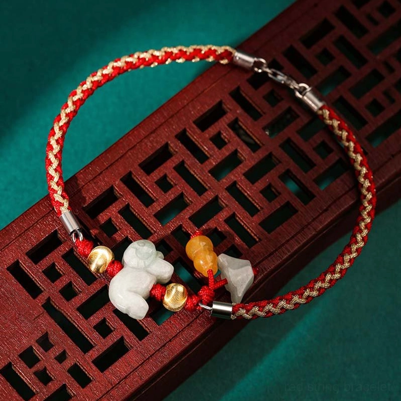 Zodiac jade red string bracelet with carved animal charm and gold accents