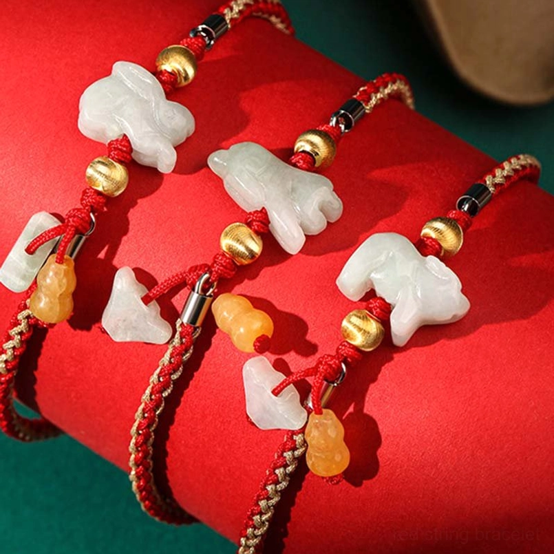 Multiple zodiac jade red string bracelets in white and yellow jade with red cord