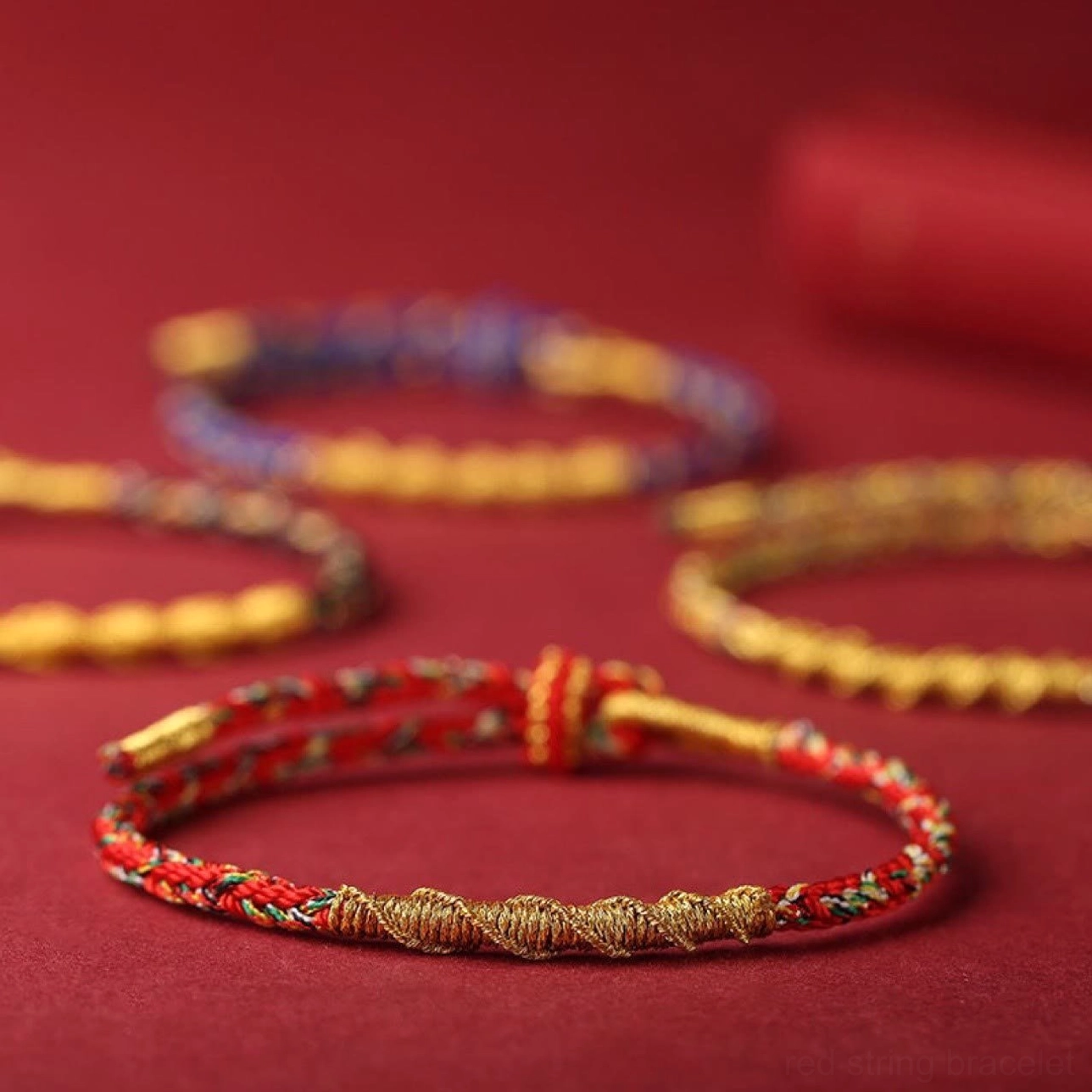 Multiple color options of chinese zodiac natal buddha red string bracelets flat lay