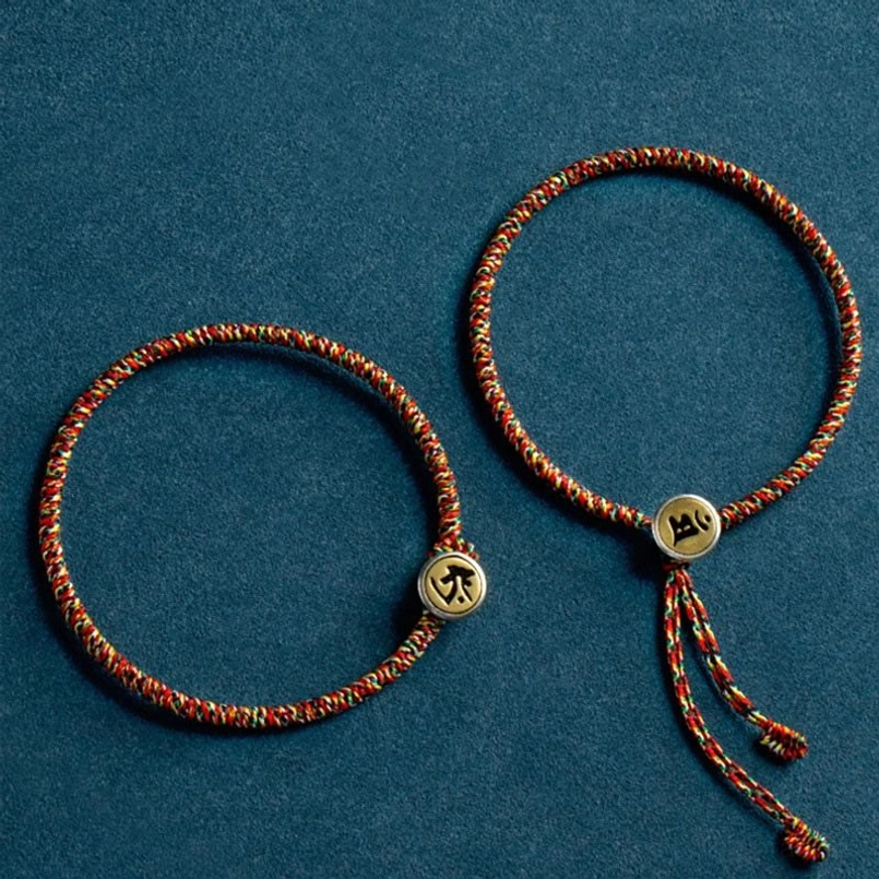 Pair of matching Chinese zodiac protection bracelets with different Buddha guardians and braided rope design