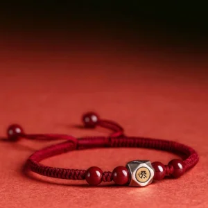 Chinese zodiac natal buddha red string bracelet with cinnabar beads and 925 sterling silver guardian bead on gradient background