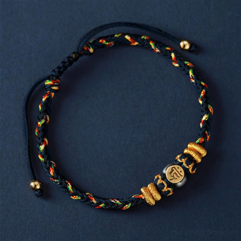 Single zodiac natal buddha bracelet with dark tone woven cord, gold and green trim, decorative knots detail