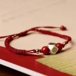 Handmade red zodiac natal Buddha cinnabar bracelet with sterling silver polygonal charm and beads