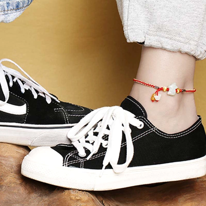 Chinese zodiac red string anklet worn on foot with sneakers casual style