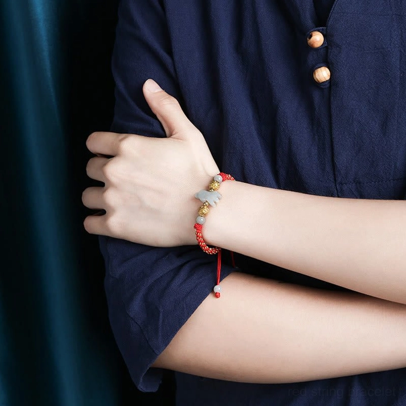 Chinese zodiac red string bracelet with natural jade carving detail