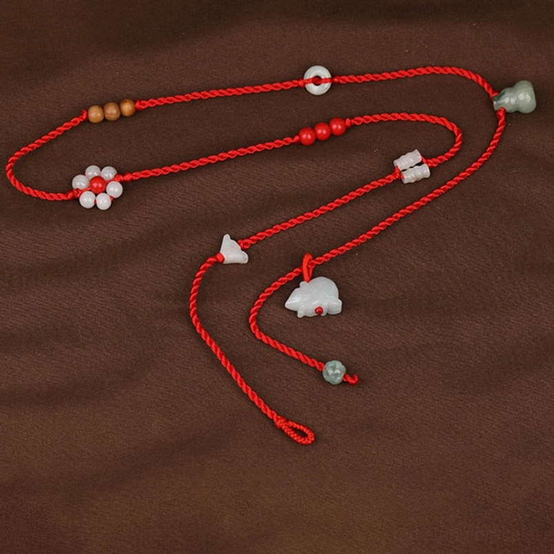 Chinese zodiac red waist chain with wooden beads and flower bead decoration on brown fabric
