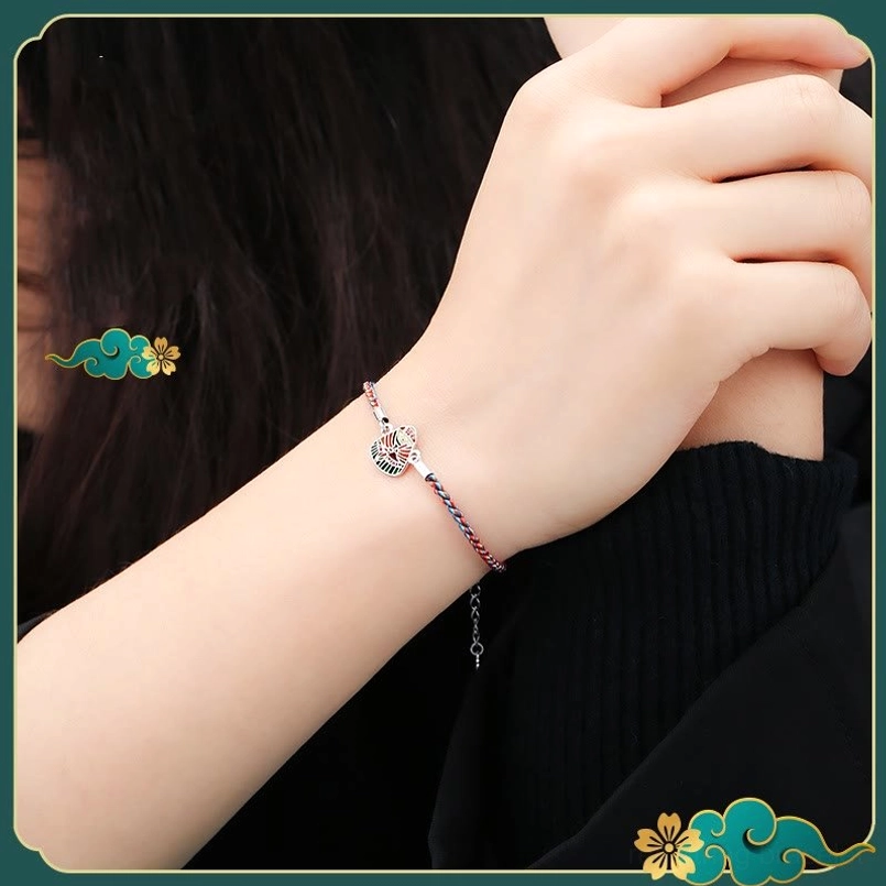 Daily wear shot of thin multicolor zongzi charm red string bracelet on wrist